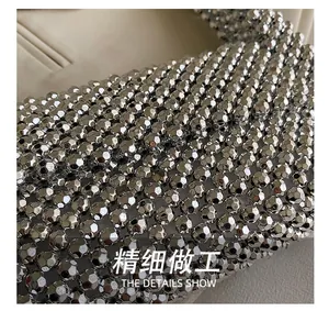 Detailed close-up of handmade silver faceted beads and intricate woven structure