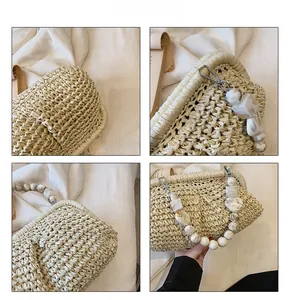 Detail view of woven straw bag featuring marble texture bead handle and bohemian metal clasp