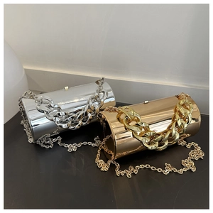 Macro shot of gold and silver metallic cylindrical clutches with chunky chain handles