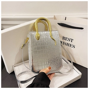 Silver crocodile embossed handbag with unique gold snake handle and long shoulder strap