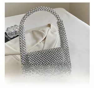 Detail showing the intricate handmade silver beadwork on the punk style shoulder bag