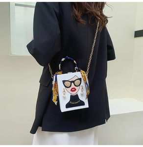 Detail of artistic box bag with cartoon woman print and pearl earring accent