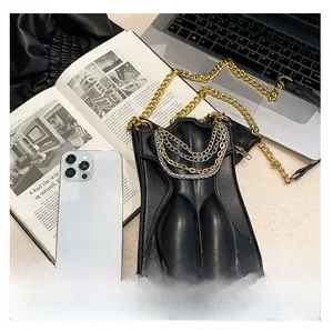 Top view of a black leather crossbody bag with silver chains and gold chain strap