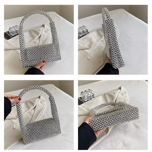 Detail view of a handmade silver beaded evening bag with luxury woven texture