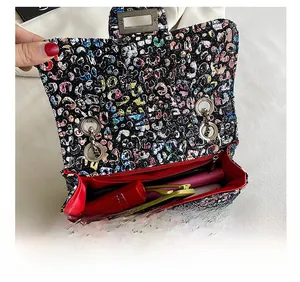 Detail view of the colorful woven crossbody bag with red lining and interior storage capacity