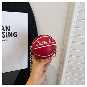Close-up of red basketball-shaped mini bag with textured surface and chain strap