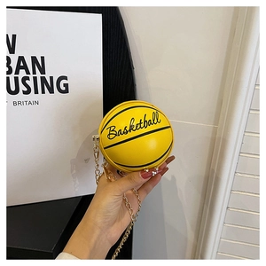 Close-up of yellow basketball-shaped mini chain bag with metallic zipper and engraving