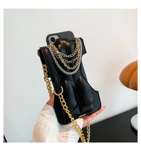 Detail of 3D female torso art on black leather crossbody phone case with gold chains