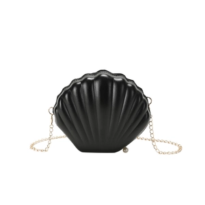 Minimalist black shell crossbody bag with golden chain and pearl charm detail