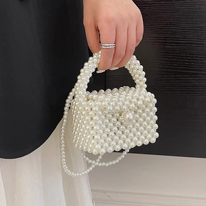 Elegant white handmade pearl woven handbag with top handle and crossbody pearl chain