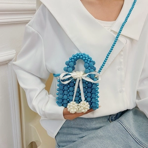 Blue beaded mini bag with white bow pendant and pearl chain strap for women
