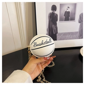 Close-up of white basketball-shaped mini chain bag with gold metallic strap detail