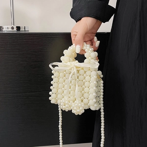 Elegant white pearl woven bucket bag with silk bow and crossbody strap for women