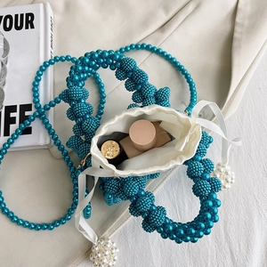 Teal pearl woven bucket bag with satin drawstring liner and long pearl shoulder strap
