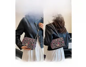 Detailed view showing the versatile shoulder and crossbody wear of the graffiti chain bag