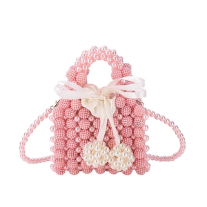 Handmade pink pearl woven handbag with silk bow and heart charms for women