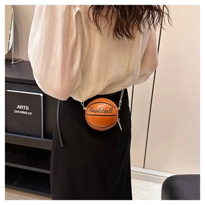 Close-up of orange basketball-shaped mini chain bag with textured PU leather surface
