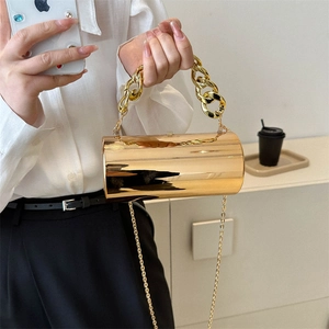 Golden cylindrical acrylic clutch bag with metallic mirror finish and chunky chain handle