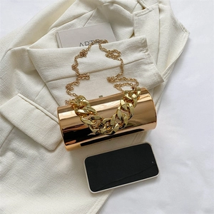 Glossy gold cylindrical acrylic clutch bag with chunky chain and long metal shoulder strap