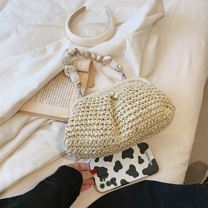 Elegant beige straw handbag with marble bead handle for summer beach vacation