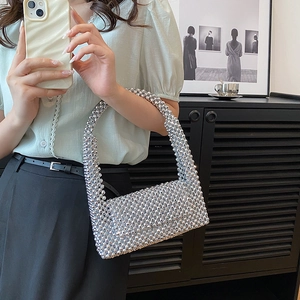 Sparkly silver beaded evening bag with a rectangular silhouette and woven strap