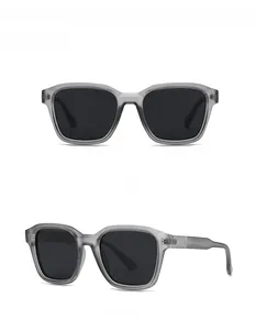 Front and 45-degree side views of square grey translucent sunglasses with black lenses