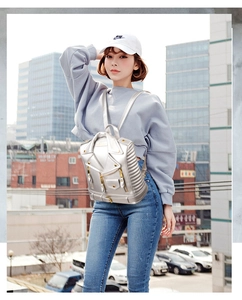Detail of silver motorcycle jacket style backpack with studs and zippers for women