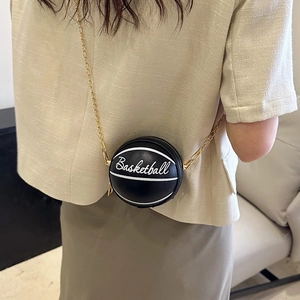 Mini black basketball-shaped crossbody chain bag with white script lettering