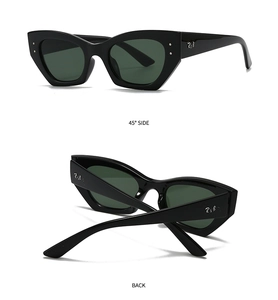Détail des lunettes de soleil œil-de-chat ovales avec monture noire et verres verts