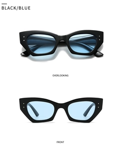 Détail de lunettes de soleil œil-de-chat ovales avec monture noire et verres bleus