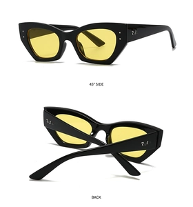 Vue détaillée de lunettes de soleil ovales tendance avec monture noire et verres jaunes