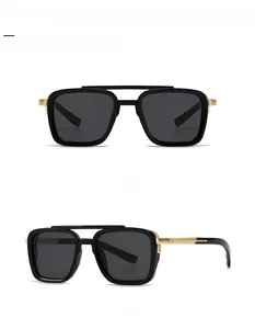 Detail of square pilot sunglasses featuring classic black frames and golden double bridge