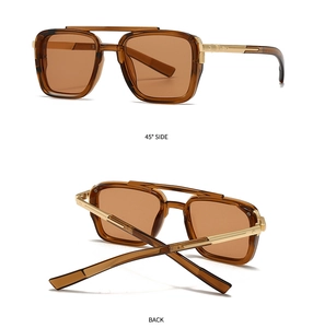 Detail of vintage aviator sunglasses showing gold double bridge and amber frame
