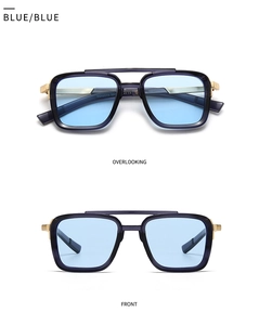 Close-up of square aviator sunglasses with gold top bar and light blue lenses