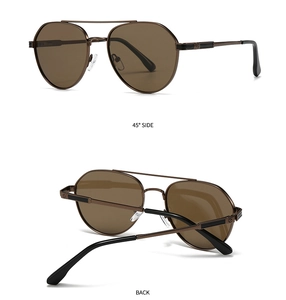 Detail view of aviator sunglasses with bronze metal frame and polarized brown lenses