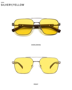 Detail of square silver metal sunglasses with yellow lenses and wood texture temples