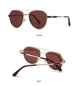 Detail view of gold aviator sunglasses with wine red lenses and screw decor