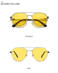 Detail view of silver metal aviator sunglasses with transparent yellow lenses and black tips