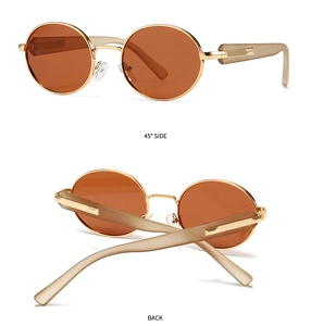 Detail view of round polarized sunglasses with golden metal frame and brown lenses