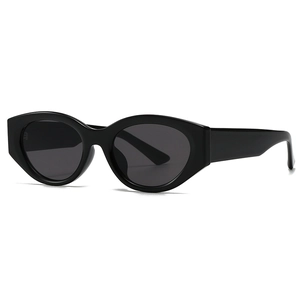 Retro black cat-eye sunglasses with thick glossy frames and dark lenses for modern street style