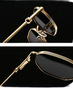Detailed macro view of gold metal sunglasses frame with textured edge and reinforced hinge