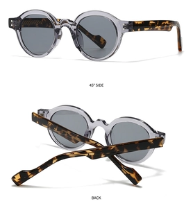 Detail view of vintage round sunglasses with grey frames and tortoiseshell temples