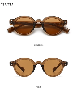 Retro round tea colored sunglasses with translucent frames and front overlooking view
