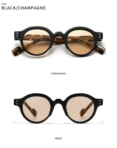 Detail of vintage round sunglasses with black frames and tortoiseshell temples