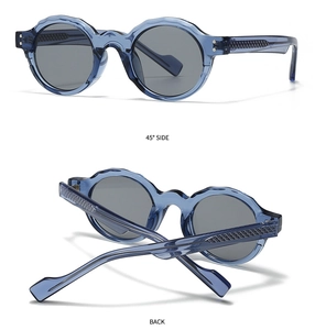 Detail view of blue translucent sunglasses with wavy frame and diamond texture temples