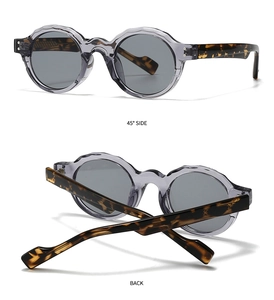 Detail of retro round sunglasses with translucent grey frame and tortoiseshell temples