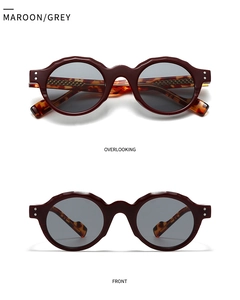 Close-up of maroon wavy frame sunglasses with tortoiseshell temples and grey lenses