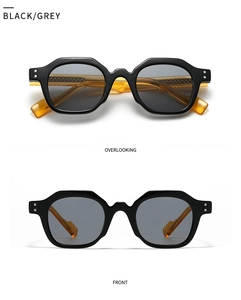 Detail view showing black geometric frames with amber temples and silver rivet accents
