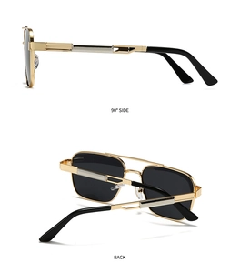 Detail view of gold metal sunglasses frame with silver accents and dark lenses