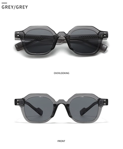 Detail of grey transparent polygon sunglasses with metal rivets and dark lenses